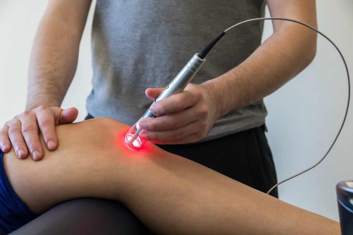 Laser therapy on a knee used to treat pain. selective focus